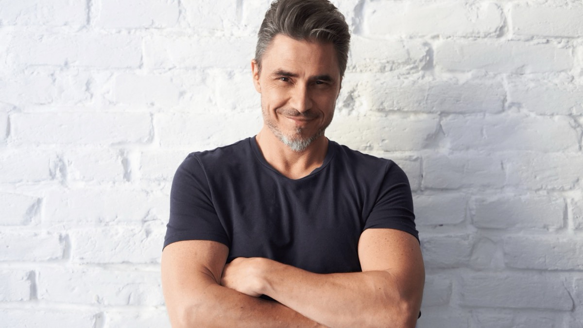 Confident middle-aged man with arms crossed
